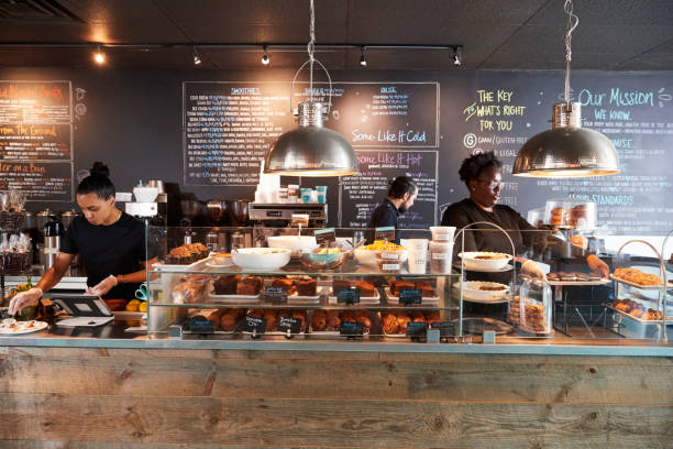 Baristas preparing drinks and pastries behind the HALO coffee counter